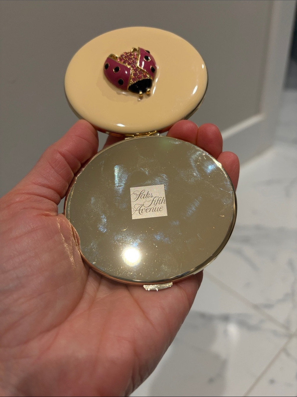 Saks Fifth Avenue Cream Compact with Pink Ladybug Accent